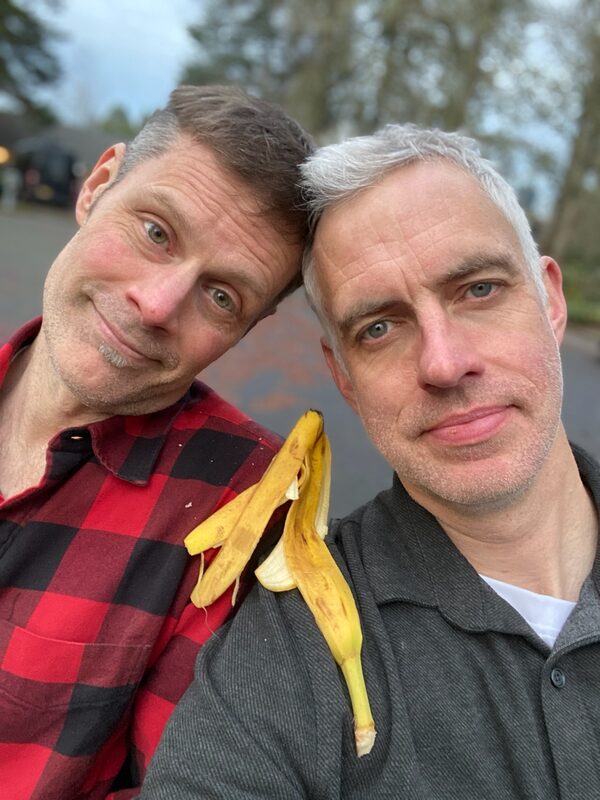 Ryan and Matt heads together with banana peel on shoulder